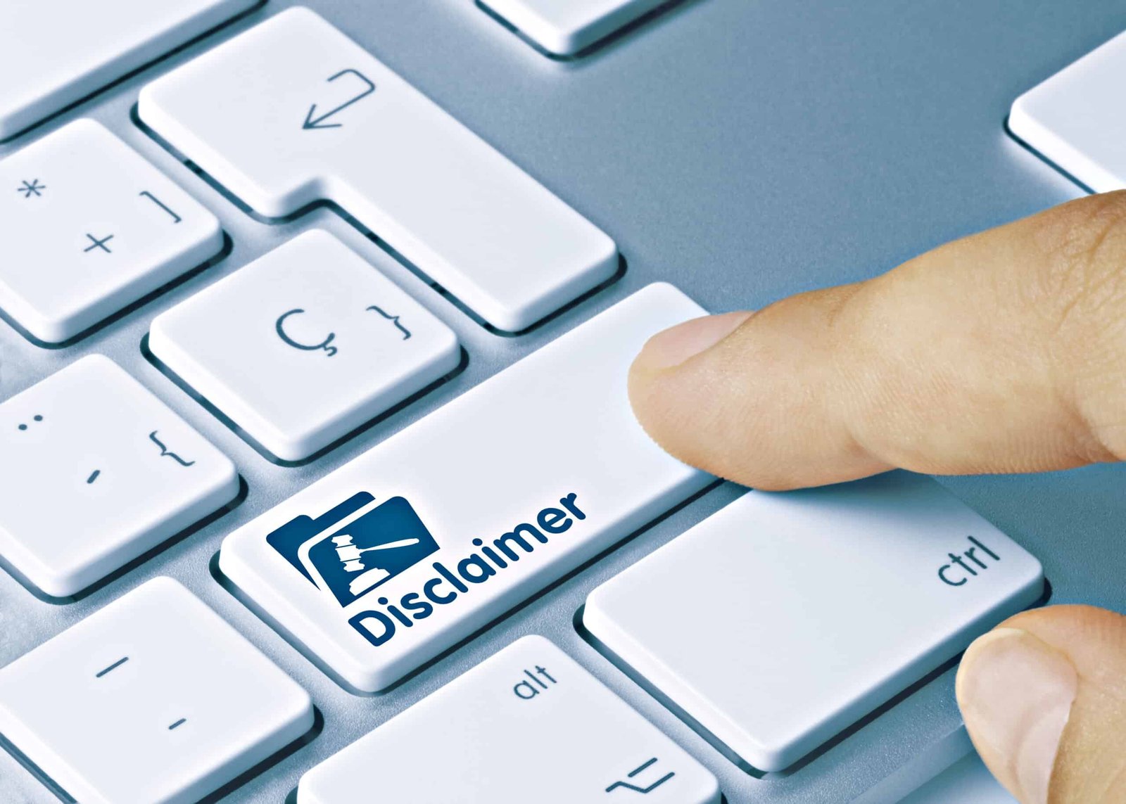 Finger pressing disclaimer key on computer keyboard