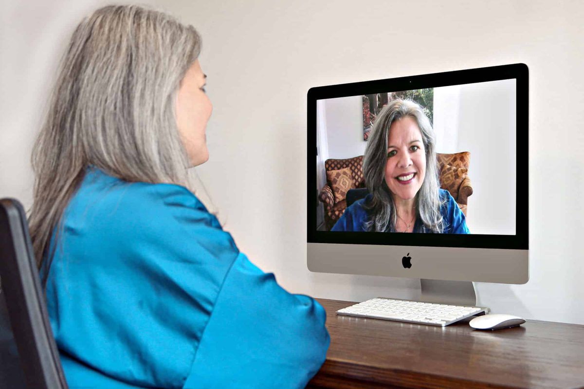Josée Brouillette, M.Ed. a woman video chatting on desktop computer at home office
